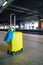 yellow valise with ukrainian flag at railway station