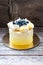 Yellow vanilla and lemon cake with meringues and fresh grapes, blueberries, blackberries