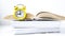 Yellow vintage alarm clock with book on white background, Back to school, Time to learn, wealth knowledge