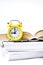 Yellow vintage alarm clock with book on white background, Back to school, Time to learn, wealth knowledge