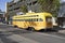 Yellow vintage bus operates from Fisherman`s wharf to market street downtown San Francisco. Tourists enjoy traveling with this