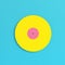 Yellow vinyl record on bright blue background in pastel colors. Minimalism concept