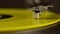 Yellow vinyl record spinning on turntable. Vintage lp player in motion