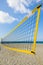 Yellow volleyball net at the beach