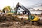 The yellow Volvo Mako is digging for the construction of an electric train on Ramkhamhaeng Road, Bangkok.