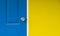 The yellow wall and close blue door for background, blue door is locked