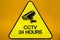 Yellow warning cctv security cameras sign operating 24 hour