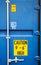 Yellow warning signs on blue container