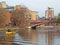 a yellow water taxi boat passing under crown point bridge over the river aire in leeds