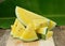 Yellow watermelon sliced on wooden background