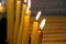 Yellow wax candles are burning at a party, holiday, close up