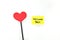 A yellow welcome back note card with a red heart. Back to work, office and school concept.