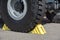 Yellow wheel chocks under the big truck wheels