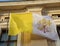 yellow and white flag of the Vatican state with the symbol of th