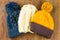 Yellow, white and gray knitting caps