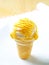 Yellow and white ice cream cone