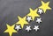 Yellow and white stars are placed on a black background for business ideas and have copy space.