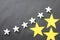 Yellow and white stars are placed on a black background for business ideas and have copy space.