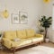 Yellow and white wall background, decorative bookshelf and book, coffee table, lamp.