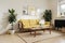 Yellow and white wall background, decorative bookshelf and book, coffee table, lamp.