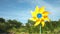 Yellow windmill spinning in wind on blue sky