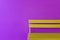 Yellow wood bench on vivid violet wall background