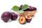 Yellow wooden basket with ripe plums, whole and half ripe plums isolated on a white background