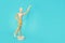 Yellow wooden maniken is dancing and doing poses on blue background