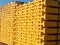 Yellow wooden piled formwork beams. Construction equipment