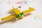 Yellow wooden toy plane on the white background. Education, children, play concept. Kids drawings with the toy.Childhood