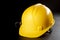 Yellow work helmet on a dark table. Protective accessories for construction workers