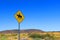 Yellow yield sign with horseback rider in the desert