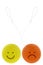 A yellow Yoyo with happy face and an orange Yoyo with sad face