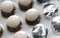 Yellowish medicine tablets packed in silver blister with some containers empty. Close up medicine background