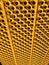 Yellowish metallic protection wall with holes pattern photo