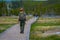 YELLOWSTONE, MONTANA, USA MAY 24, 2018: Outdoor view of female park ranger wearing a green uniform with a backpack