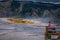 YELLOWSTONE, MONTANA, USA MAY 24, 2018: Unidentified man sitting in a chair in front of Canary Springs on terraces of