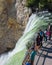 YELLOWSTONE NATIONAL PARK, WYOMING, USA - JULY 17, 2017: Tourists and a tour guide watching Lower Yellowstone Falls. Grand Canyon