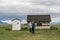 YELLOWSTONE NATIONAL PARK, WYOMING, USA - JUNE 17, 2018: Tourists near the House At Moulton Barns on a prairie grass field