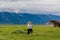 YELLOWSTONE NATIONAL PARK, WYOMING, USA - JUNE 17, 2018: Tourists near the House At Moulton Barns on a prairie grass field