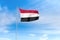 Yemen flag over blue sky background