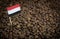 Yemen flag sticking in roasted coffee beans. Concept of export and import