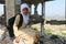 A Yemeni child stands amid the destruction of her school