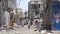 A Yemeni walking amid the devastation of war in the city of Taiz
