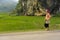 Yen Bai, Vietnam - Apr 11, 2014: Unidentified Thai woman walks home along rice field and rocky hills