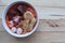 Yentafo noodles, red sauce with fishes ball in the bowl, Thai delicious food isolated on wooden background closeup.