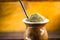 Yerba mate tea in wooden bowl on wooden table. Traditional drink from Brazil, Argentina, Paraguay and South America