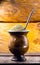 Yerba mate tea in wooden bowl on wooden table. Traditional drink from Brazil, Argentina, Paraguay and South America