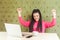 Yes! Beautiful amazed satisfied positive young girl freelancer with black dreadlocks hairstyle in pink blouse sitting and looking