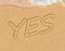 YES concept, positive changes in the life, word written on sand beach